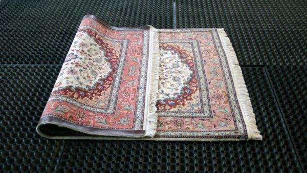 a folded fine tabriz rug