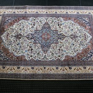 a kashmir rug on a cleaning mat