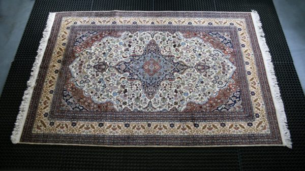 a kashmir rug on a cleaning mat