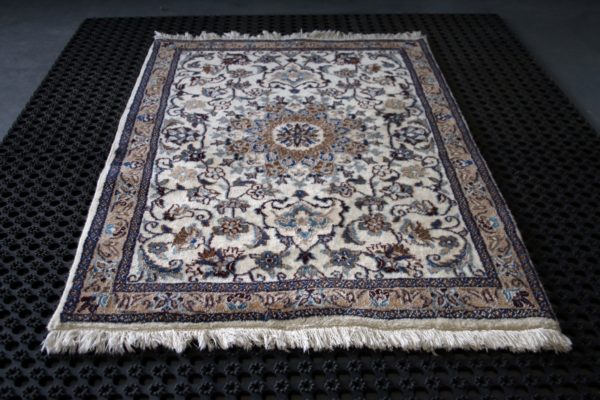 a nain rug on a black cleaning pad