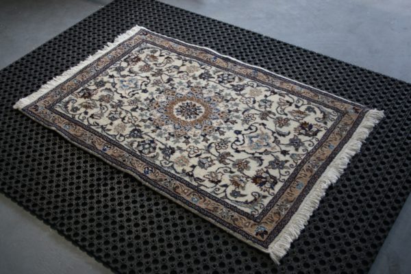 a nain rug on black cleaning mats