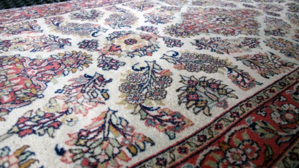 close up of a qom rug