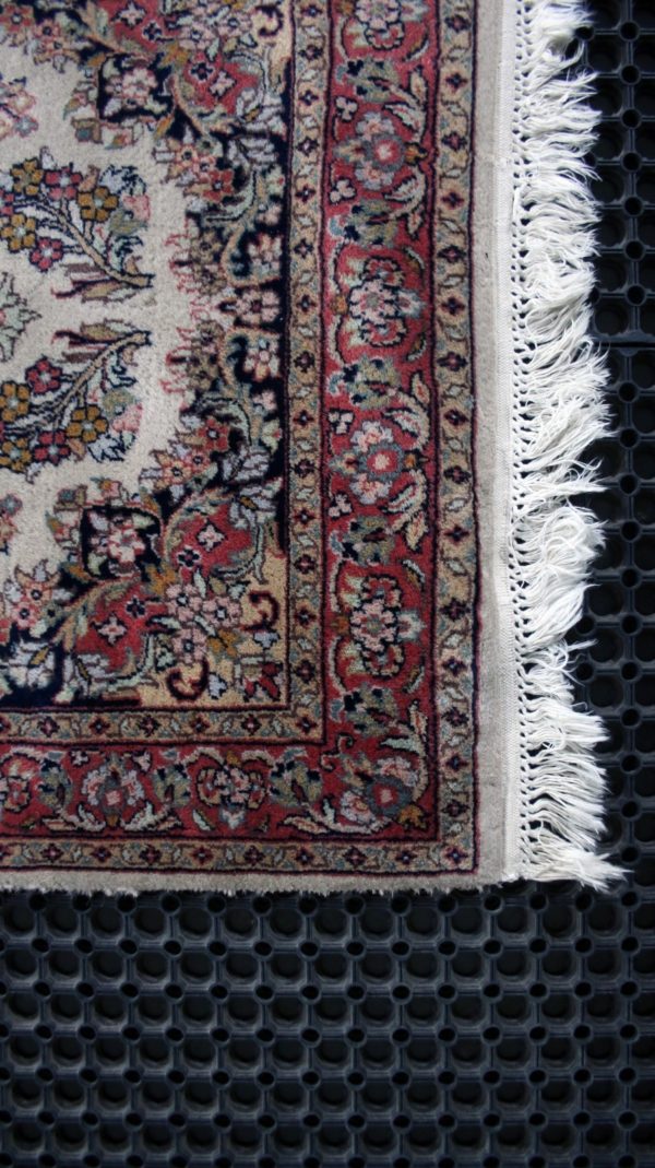 close up of a qom rug