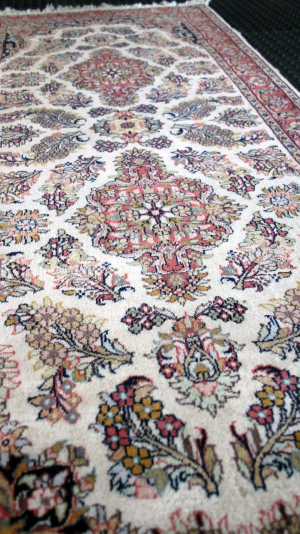 close up of a qom rug